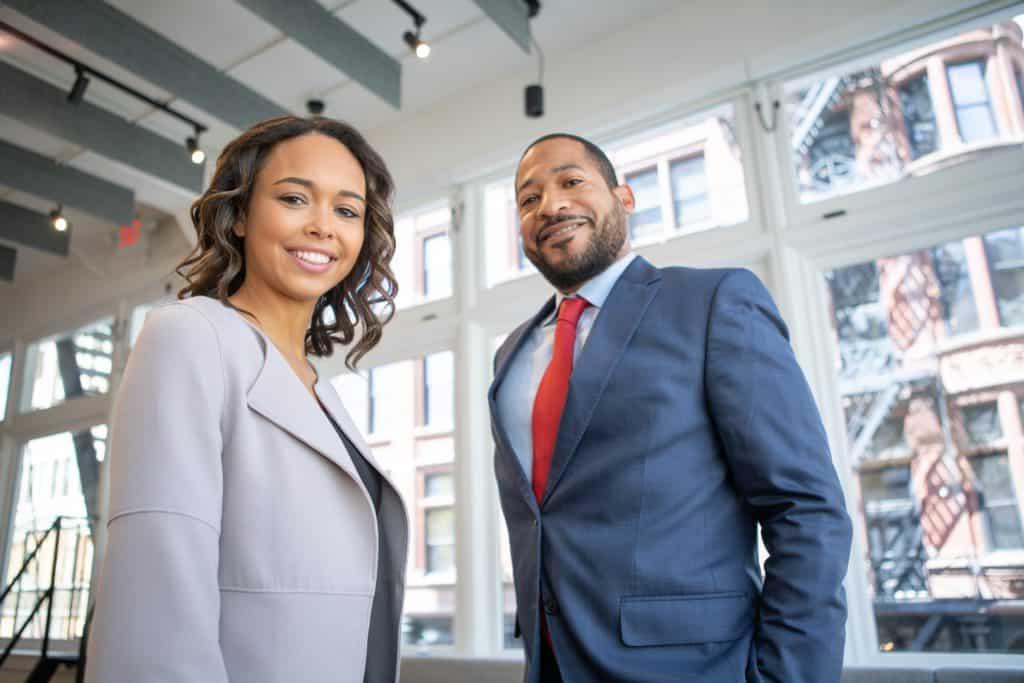 man-and-woman-smiling-inside-building