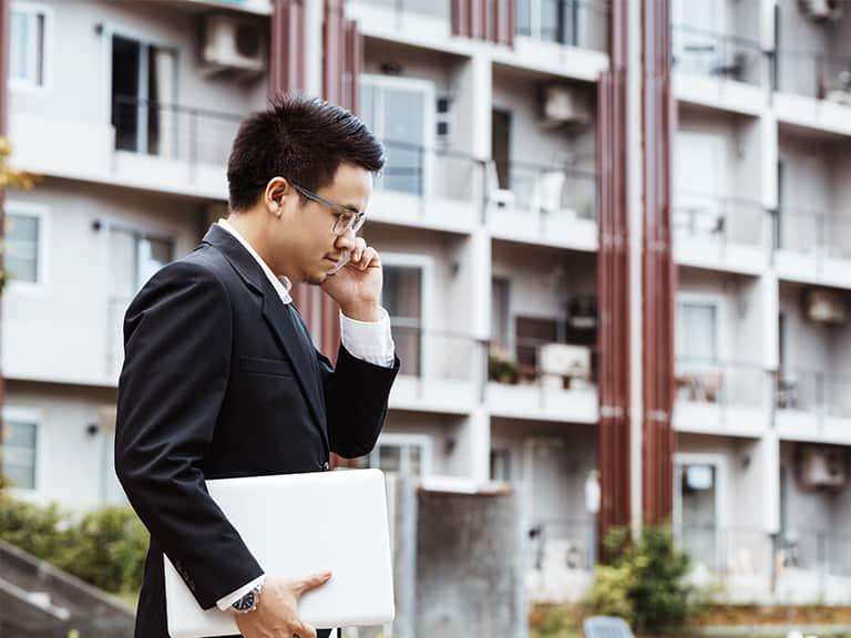 A business professional talking on the phone about Property Management