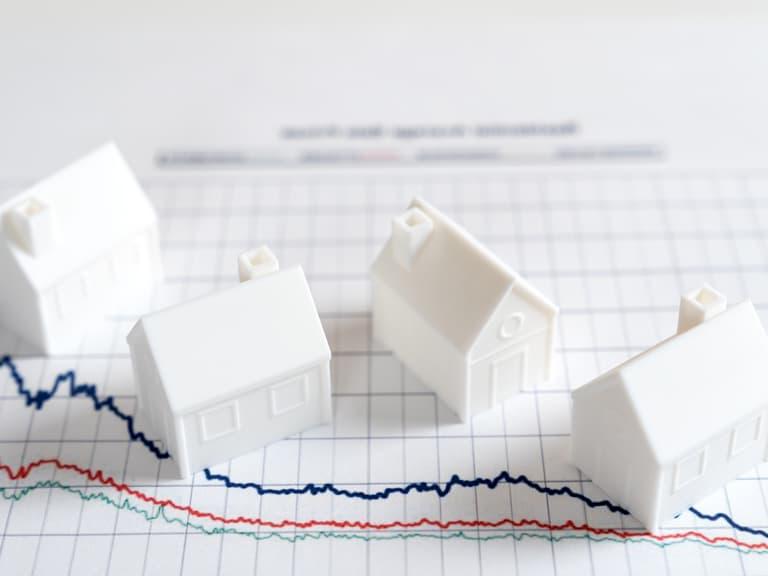 Model houses on a graph representing the commercial real estate market